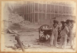 Group of British sailors posing in front of the Beit al-Ajaib - Bombardment of Zanzibar 1896 - Winterton Collection of East African Photographs: 58-5-2