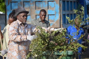 President Magufuli helps clean the street outside State House in Dec 2015 (photo State House)